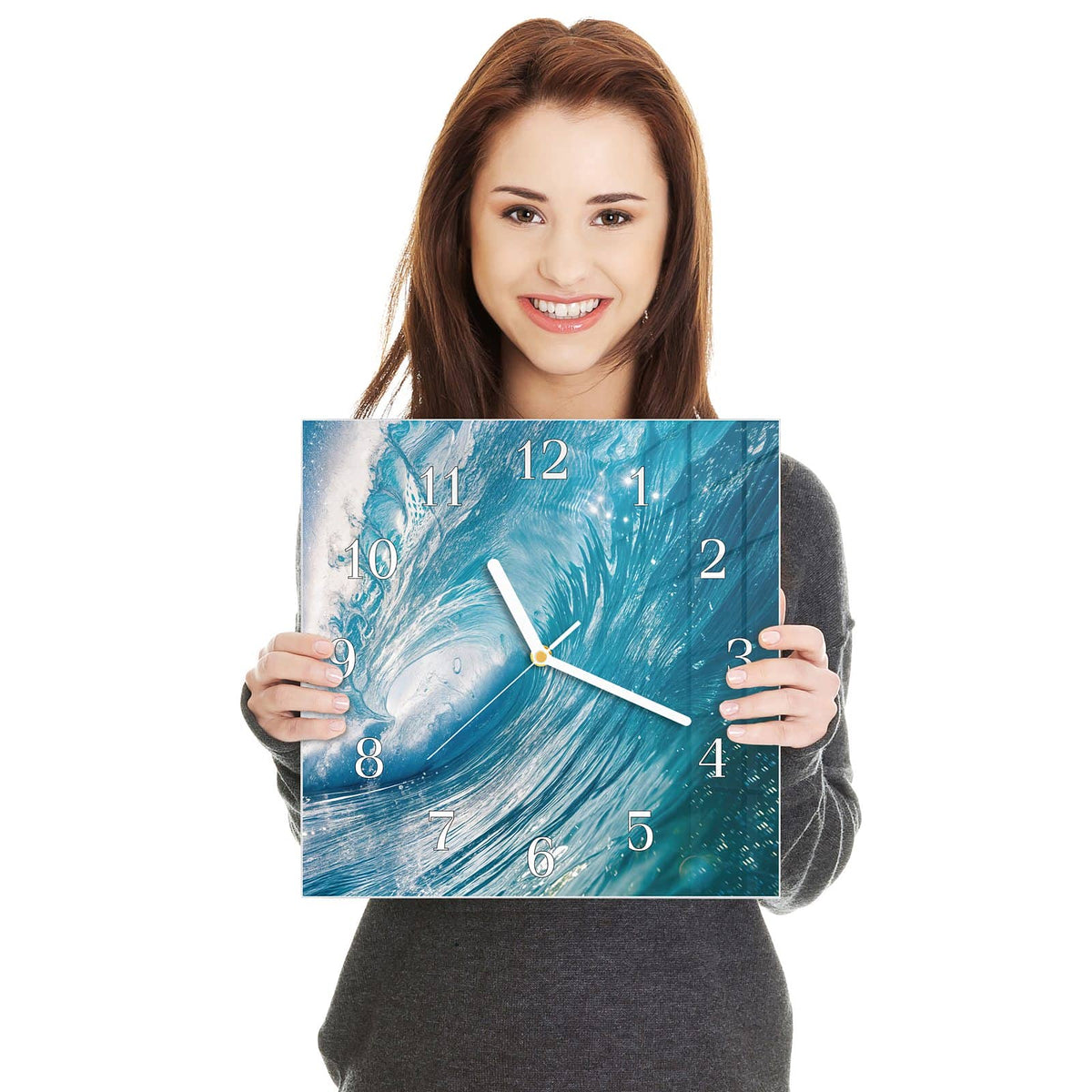 Quadratische Wanduhr aus Glas Blaue Welle mit Gischt in zwei Händen gehalten – Größenvergleich, 30 × 30 cm