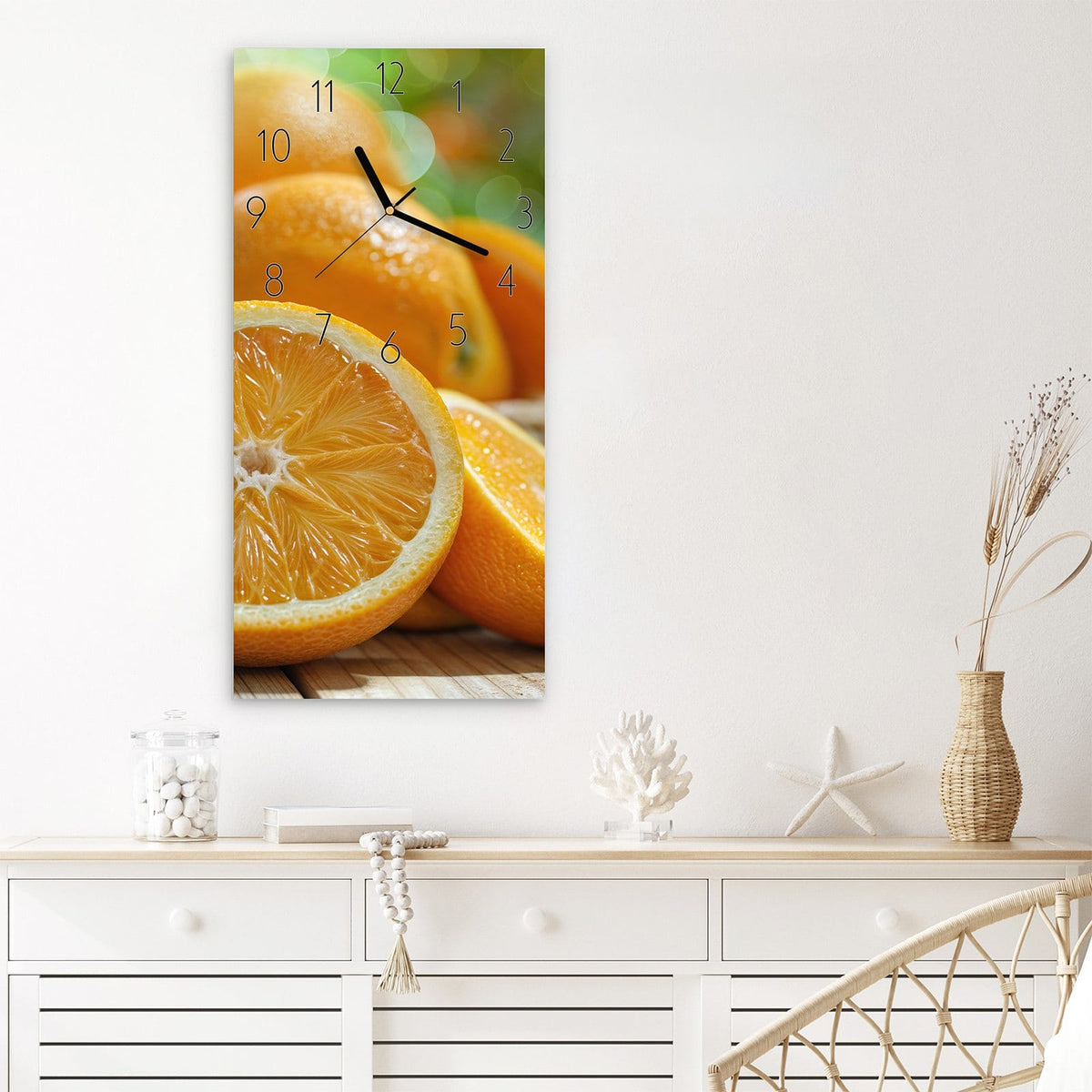 Wanduhr aus Glas im Hochformat Orangen auf Holz mit Ziffernblatt Elegant über einem weißen Sideboard