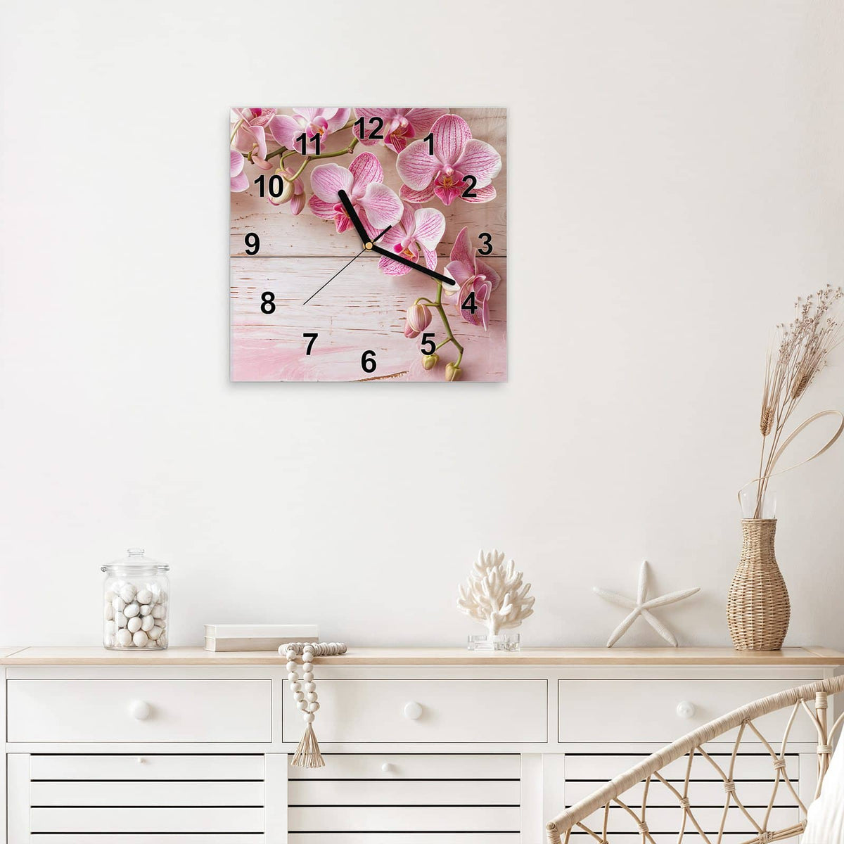 Quadratische Wanduhr aus Glas Orchideen auf Rosa mit Ziffernblatt Modern über einem weißen Sideboard