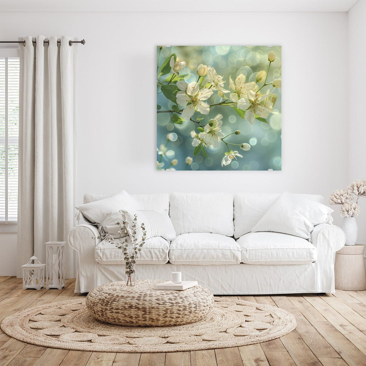 Glasbild Frühlingserwachen an der Wand – Weiße Blüten und junge Blätter an einem Zweig vor blaugrünem Bokeh