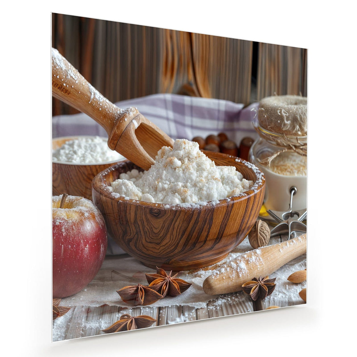 Holzschale mit Mehl, Nudelholz, roter Apfel, Sternanis und Vorratsgläser auf Holztisch