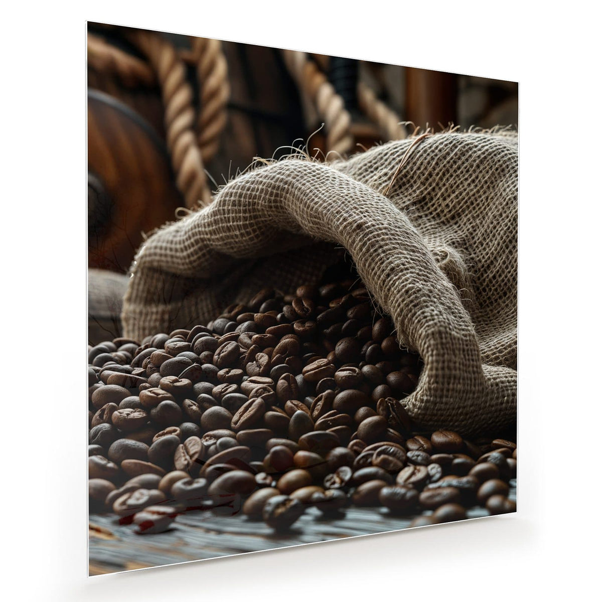 Dunkle Kaffeebohnen, die aus einem geöffneten Jutesack auf den Tisch quellen