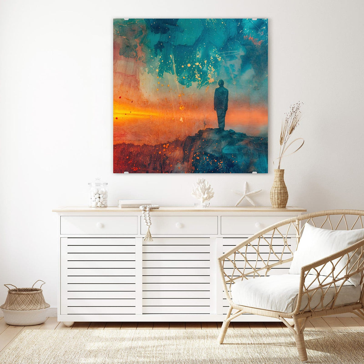 Glasbild Silhouette am Horizont an der Wand – Eine einzelne Silhouette auf einem Felsen vor türkisem Himmel und orange glühendem Horizont über Wasser