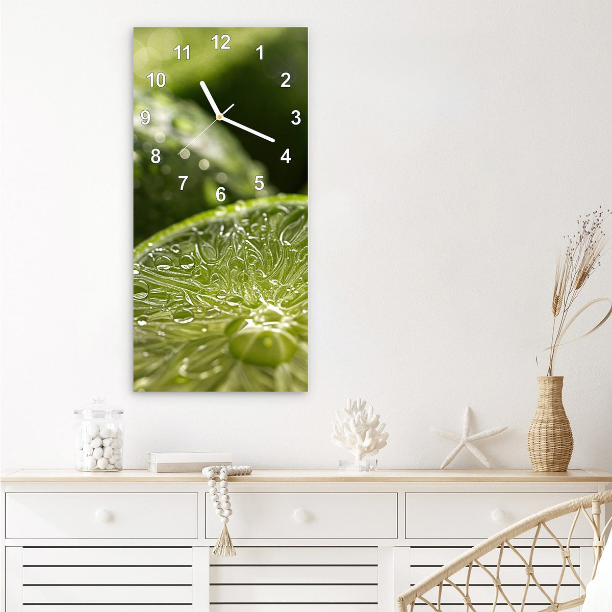Wanduhr aus Glas im Hochformat Nasse Limettenscheibe mit Ziffernblatt Modern über einem weißen Sideboard