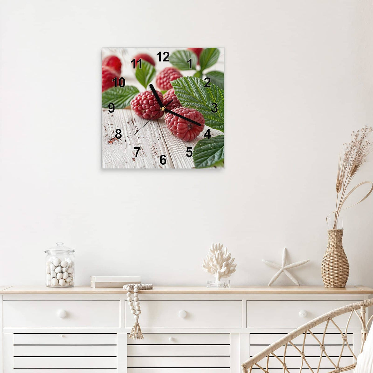 Quadratische Wanduhr aus Glas Himbeeren auf Weiß mit Ziffernblatt Modern über einem weißen Sideboard