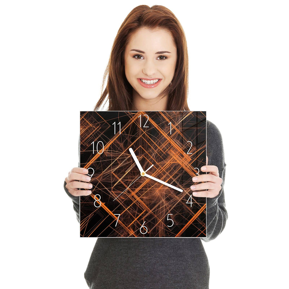 Quadratische Wanduhr aus Glas Orange Lichtlinien in zwei Händen gehalten – Größenvergleich, 30 × 30 cm