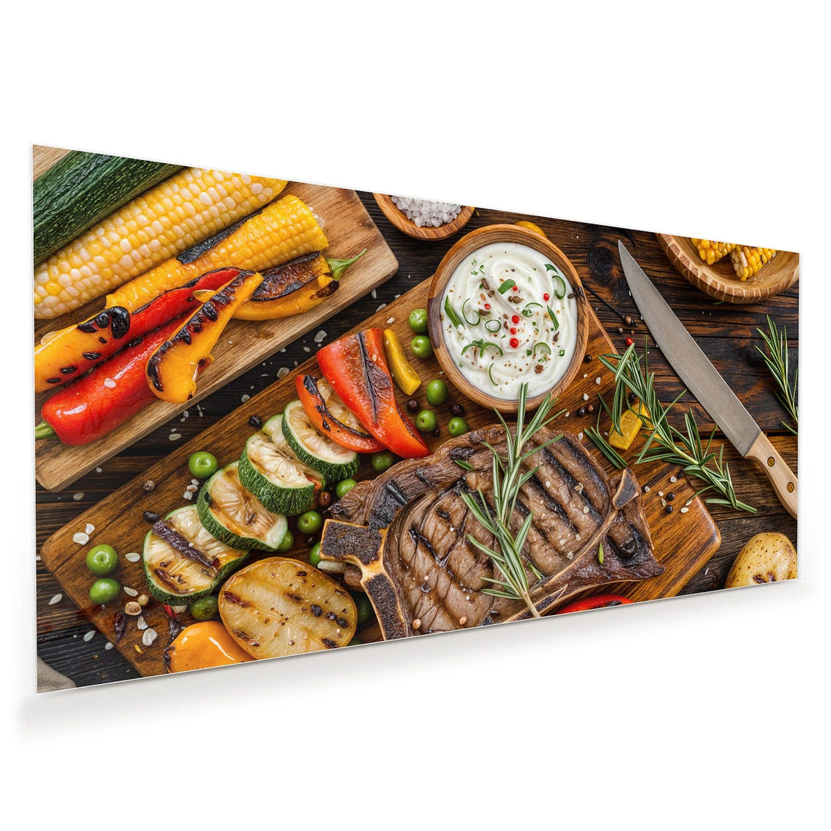 Gegrilltes T-Bone-Steak mit Rosmarin auf Holzbrett, daneben Grillgemüse, Mais, Kartoffeln und eine Dip-Schale.