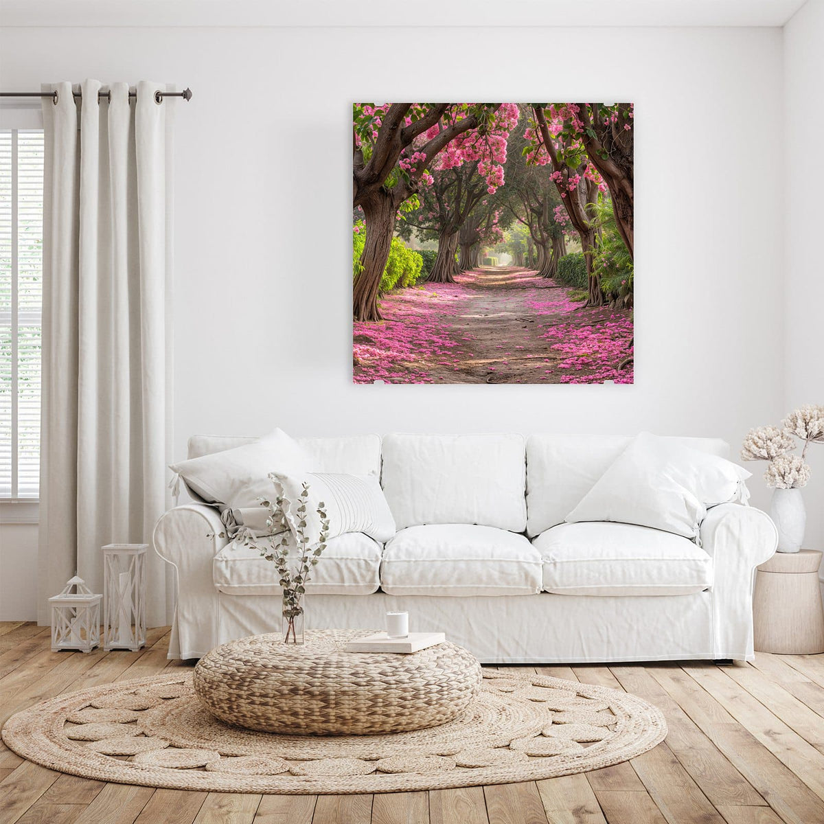 Glasbild Blütenallee an der Wand – Sandweg unter alten Bäumen voller rosa Blüten, Boden mit Blütenblättern bedeckt