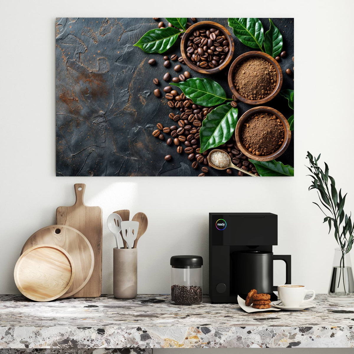 Drei Holzschalen mit Kaffeebohnen und Kaffeepulver, dazwischen ganze Bohnen und große grüne Kaffeeblätter auf dunklem Stein