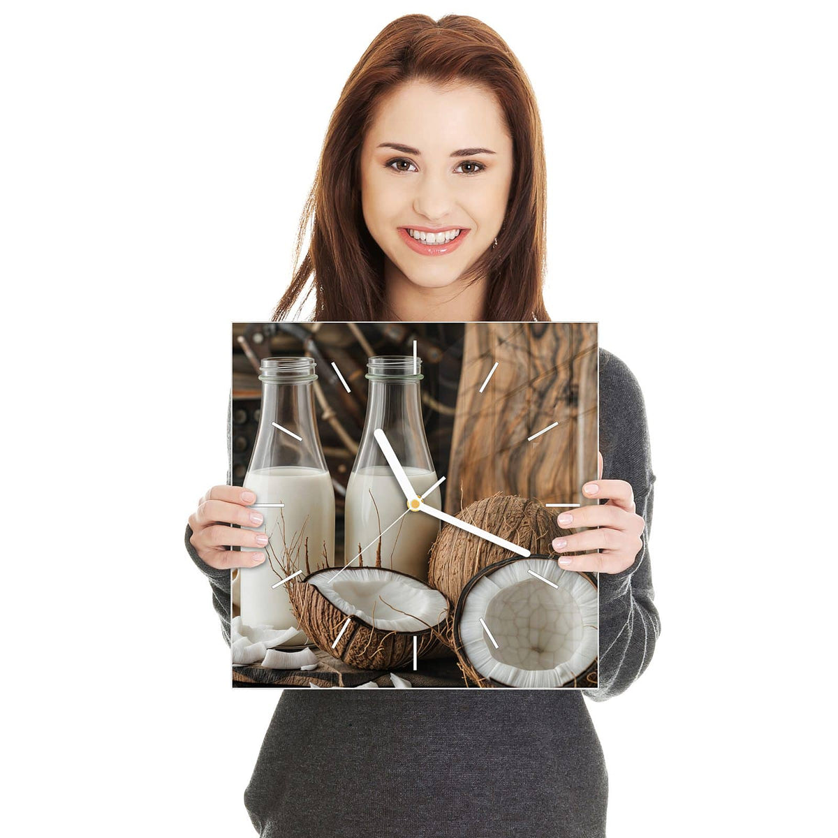 Quadratische Wanduhr aus Glas Kokosmilch in zwei Händen gehalten – Größenvergleich, 30 × 30 cm
