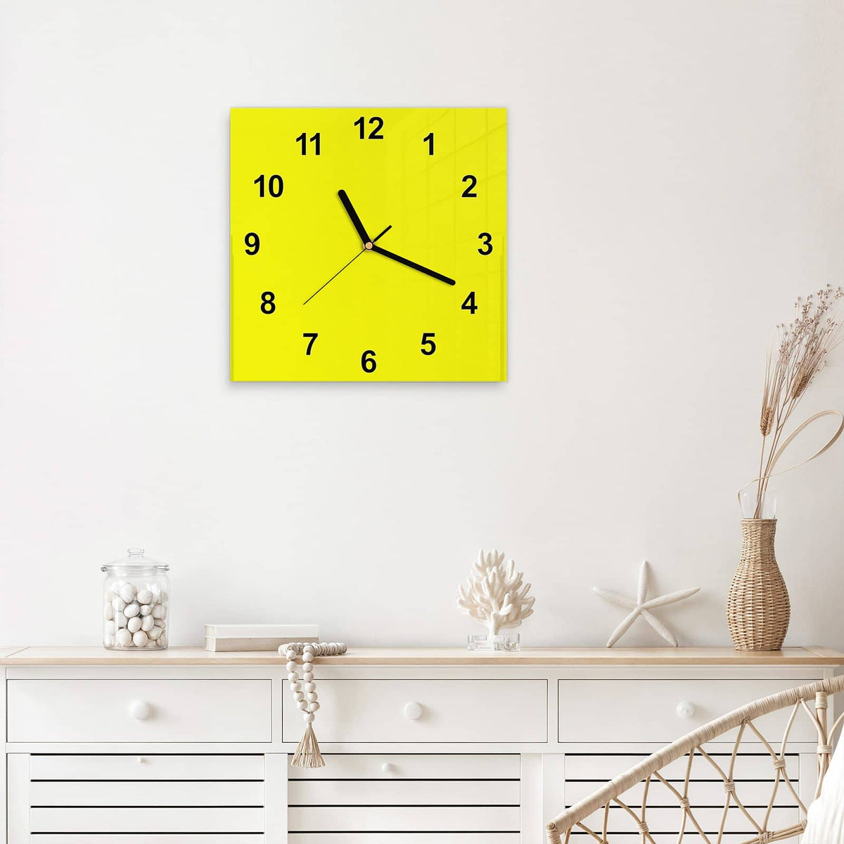 Quadratische Wanduhr aus Glas Zitronengelb mit Ziffernblatt Modern über einem weißen Sideboard